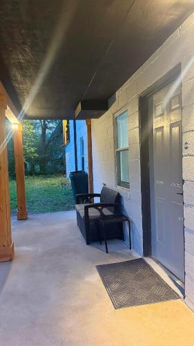 a patio with a black chair and a door at 1BR Oasis Escape in SE Atlanta in Atlanta