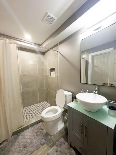 a bathroom with a toilet and a sink and a shower at 1BR Oasis Escape in SE Atlanta in Atlanta