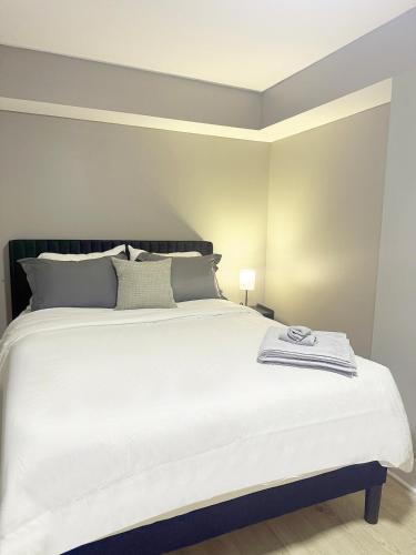 a bedroom with a large white bed with a lamp at 1BR Oasis Escape in SE Atlanta in Atlanta