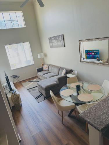 a living room with a couch and a table and chairs at Loft Style,2 Beds ,Flexible self check in,Pool in Marina del Rey
