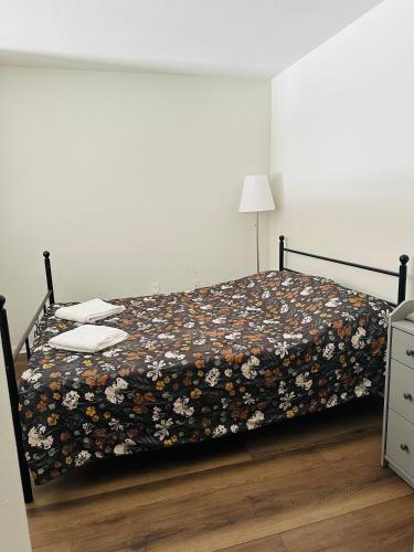a bedroom with a bed with a floral bedspread at Loft Style,2 Beds ,Flexible self check in,Pool in Marina del Rey