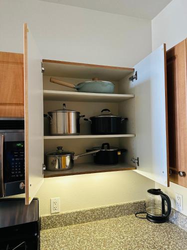 a kitchen cabinet with pots and pans on it at Loft Style,2 Beds ,Flexible self check in,Pool in Marina del Rey