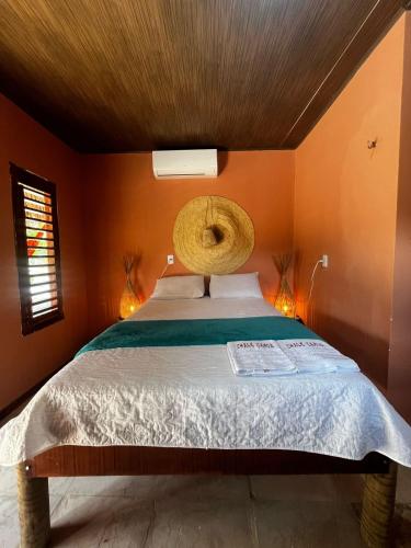 a bedroom with a bed with a basket on the ceiling at Point lanabarra in Amontada