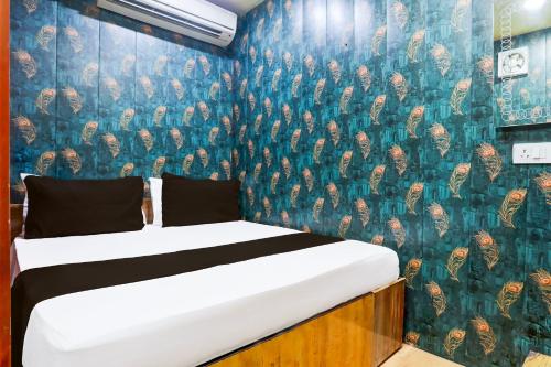 Ένα ή περισσότερα κρεβάτια σε δωμάτιο στο Hotel O A K Residency