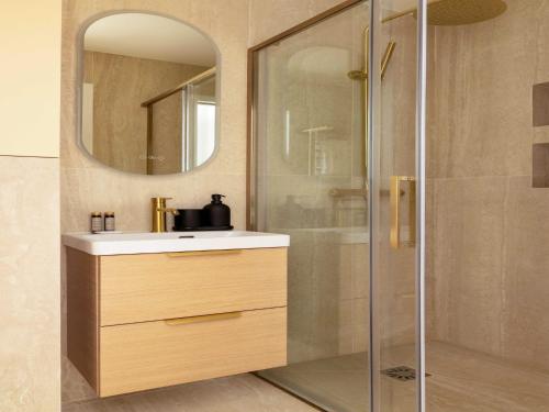 a bathroom with a sink and a shower with a mirror at Charming studio 2P- Montorgueil in Paris