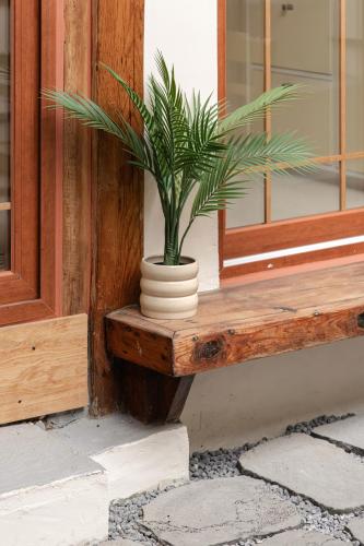 a plant in a vase sitting on a window sill at Sabrina at Hanok in Seoul