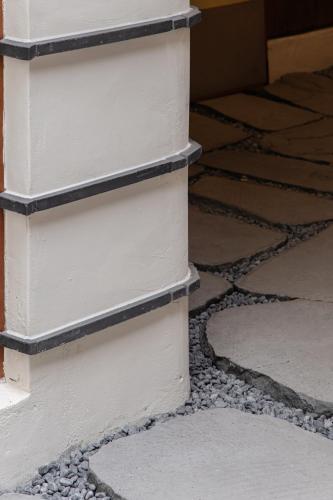 a corner of a white wall with rocks on the floor at Sabrina at Hanok in Seoul