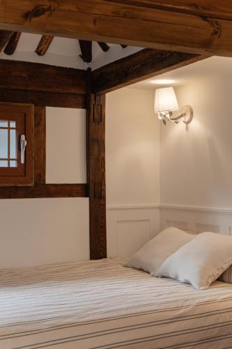a bedroom with a bed with a light on the wall at Sabrina at Hanok in Seoul