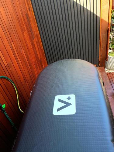 a close up of a laptop with a sign on it at Romanic Garden View 1 bed Apartment with ocean views at Stanwell Tops in Stanwell Park