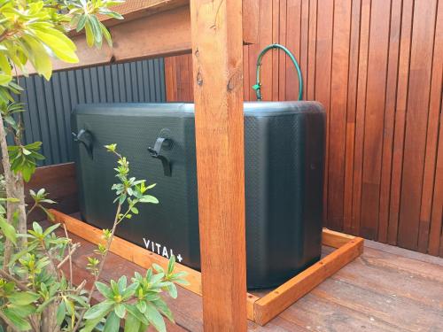 two suitcases are sitting in a wooden box at Romanic Garden View 1 bed Apartment with ocean views at Stanwell Tops in Stanwell Park