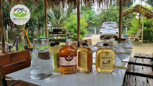 a table with several bottles of alcohol on it at YÊN Homestay in Dien Ban