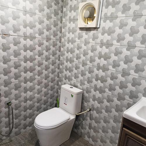 a bathroom with a toilet and a sink at Raniah Homestay 2 in Kuching