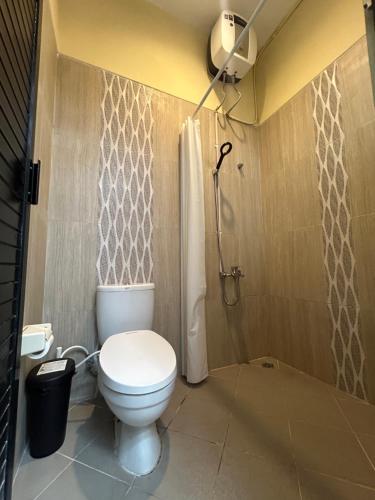 a bathroom with a toilet and a shower at Dea's House Homestay in Blimbing
