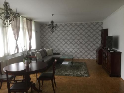a living room with a couch and a table at Apartments Vila Cvetka Bled in Bled