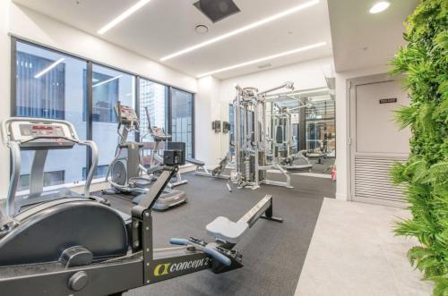 a gym with treadmills and machines in a building at 180 Degrees Seaview and Harbor View 2 bedroom Apartment in Auckland