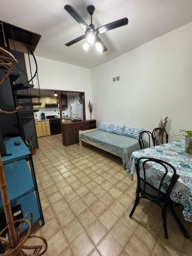 a living room with a bed and a ceiling fan at CasaSansaba in Gerli