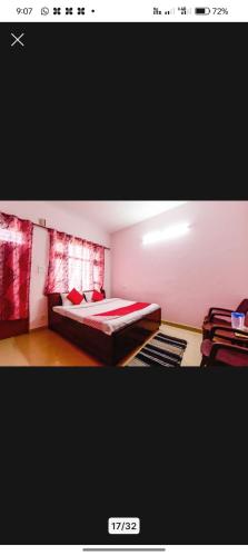 a bedroom with a bed with a red blanket at Prem Home Stay in Sundarnagar