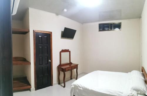 a bedroom with a bed and a mirror and a chair at El Paso de Almirante in Almirante