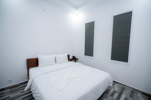 Uma cama ou camas num quarto em Bona Hotel