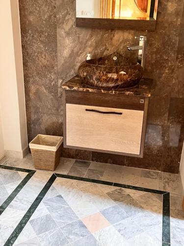 a bathroom with a sink on a tiled floor at Private floor of a villa - 10 min to airport in Ariana
