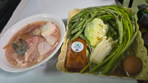 a plate of food with a bowl of soup and vegetables at Riverhill khaoyai camping เต้นท์โดม in Wangkata