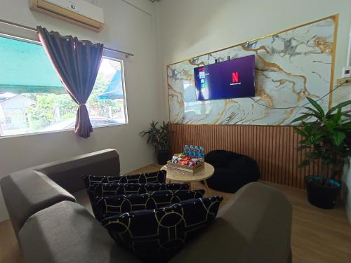 a living room with a couch and a table with a cake at Near Central Festival Hat Yai,5-8 people in Hat Yai