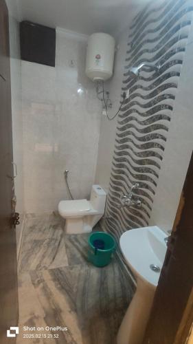 a bathroom with a toilet and a sink at Prime Hotel - 2 Mins From Durgabai Deshmukh South Campus Metro in New Delhi