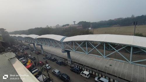 a parking lot with cars parked in front of a building at Prime Hotel - 2 Mins From Durgabai Deshmukh South Campus Metro in New Delhi
