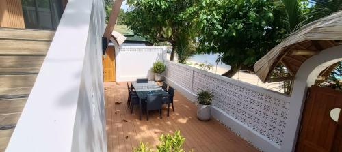 a balcony with tables and chairs on a building at โรงแรมชาวเกาะพีพี Chaokoh Phi Phi Island in Phi Phi Don