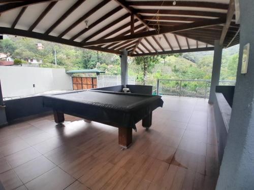 a pool table in a room with a roof at Rancho Moralito, un lugar magico in San Carlos