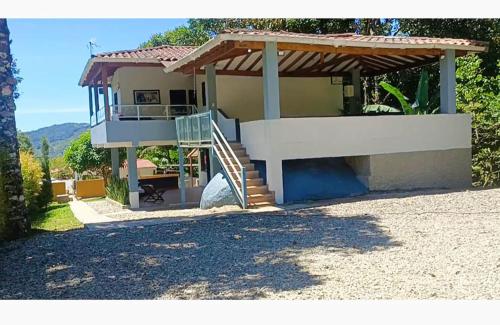 a house with a staircase in front of it at Rancho Moralito, un lugar magico in San Carlos