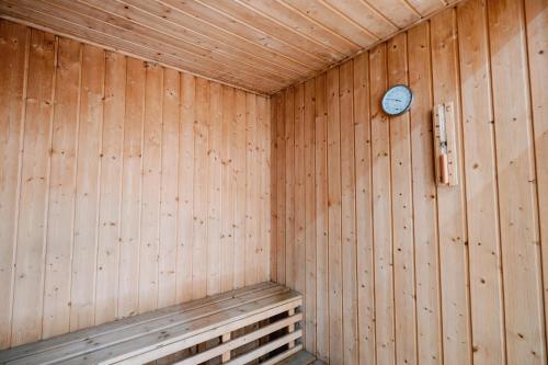 a wooden sauna with a clock on the wall at Spacious 2BR at SoMa BGC Near SM Aura and Bonifacio High Street in Manila