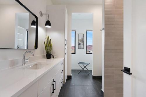 a white bathroom with two sinks and a shower at Luxury Desert Oasis in Kanab Near Zion Family in Kanab