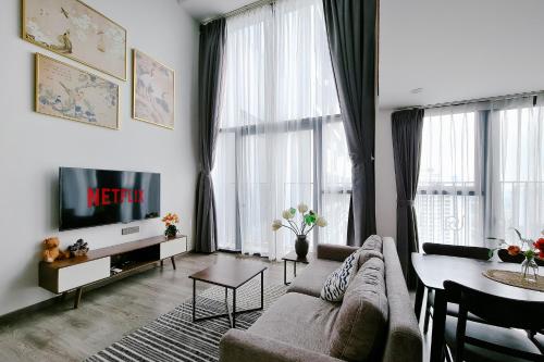 a living room with a couch and a table at Muse Hanoi PentStudio West Lake in Hanoi