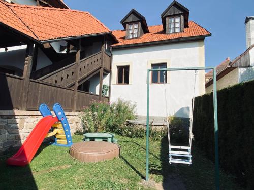 a playground in a yard with a swing at Dalmo in Sedlec