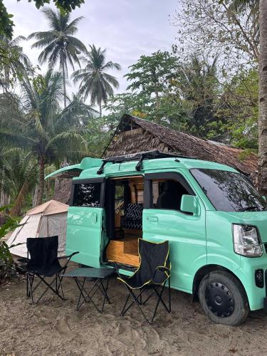a green van with two chairs and a tent at Camper Van for Rent-Mini , El Nido in El Nido