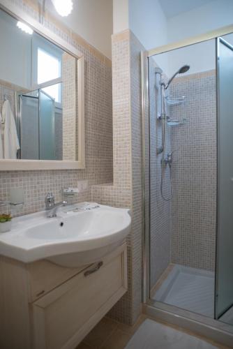 a bathroom with a sink and a shower at B&B Corte dell' Immacolata in Taviano