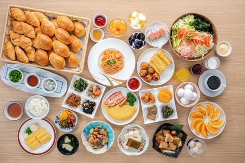 a table with many plates of food on it at Yumoto Kanko Hotel Saikyo in Nagato