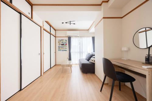 a small apartment with a desk and a couch at Tokyo Kitasen 4 in Tokyo