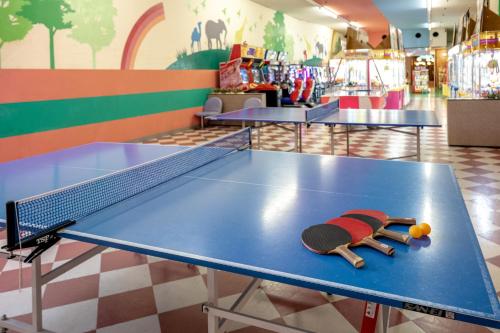 a table with a ping pong racket and balls on it at Yumoto Kanko Hotel Saikyo in Nagato