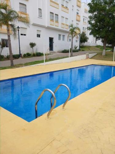 a swimming pool in front of a building at Jardin latlantique in Tangier