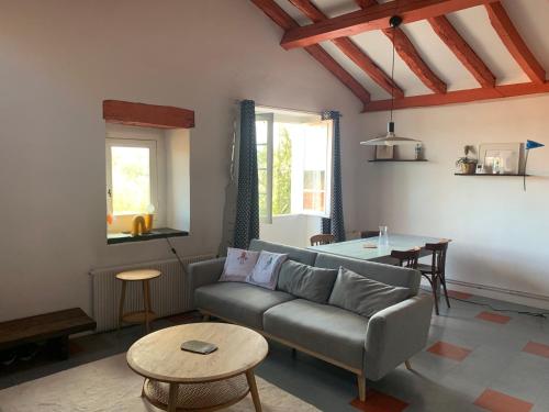 un salon avec un canapé et une table dans l'établissement Appartement Espelette, à La Celle-sous-Gouzon