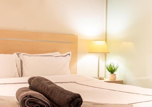 a bedroom with a bed with a towel on it at Koala Nest in Central Adelaide in Adelaide
