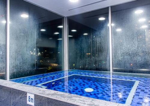 a swimming pool in the middle of a building at Koala Nest in Central Adelaide in Adelaide