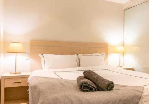 a bedroom with a bed with a towel on it at Koala Nest in Central Adelaide in Adelaide