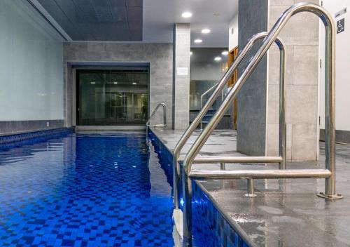 a swimming pool with stairs in a building at Koala Nest in Central Adelaide in Adelaide
