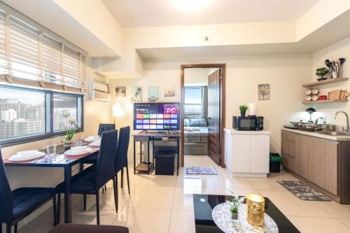 a kitchen and dining room with a table and chairs and a dining room at NEW and COZY! Good for 1-5 Guests, 1BR, free Pool & Gym, Kids Place and Billard in Horizon 101 in Cebu City