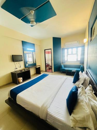 a bedroom with a large bed with a ceiling at Mangal Darshan I just 1km from shreenathji temple 966o9o1oo6 in Nāthdwāra