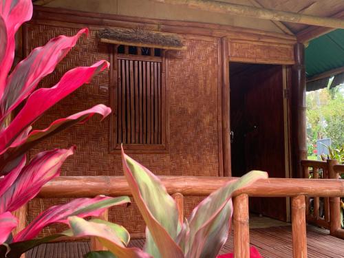 a porch with a brick building with a window at Farmer homestay in Tetebatu