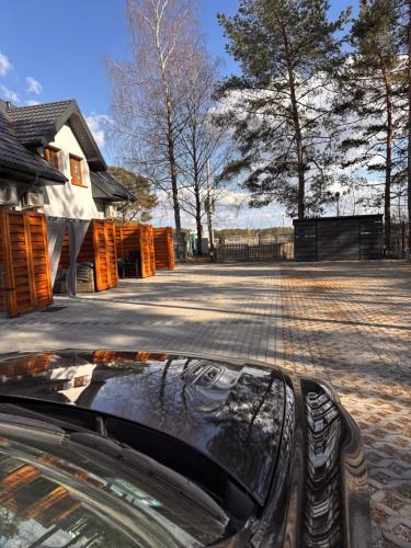 a car parked in a parking lot next to a building at Apartament Exclusive Premium Sielpia w Sielpi Wielkiej z jacuzzi na życzenie in Sielpia Wielka